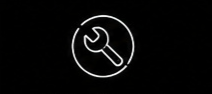 White outline of a spanner inside a circle on a black background.